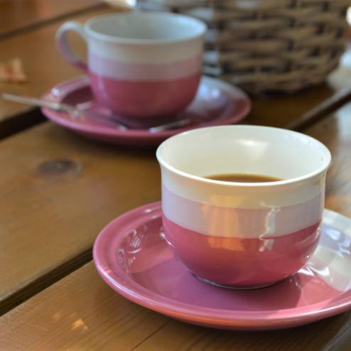 vaaleanpunaiset kahvikupit pöydällä.